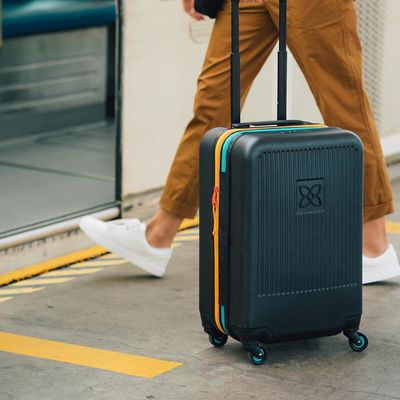 Durable suitcase with anti crush exterior mesh compression panel and compression strap designed for hassle free travel